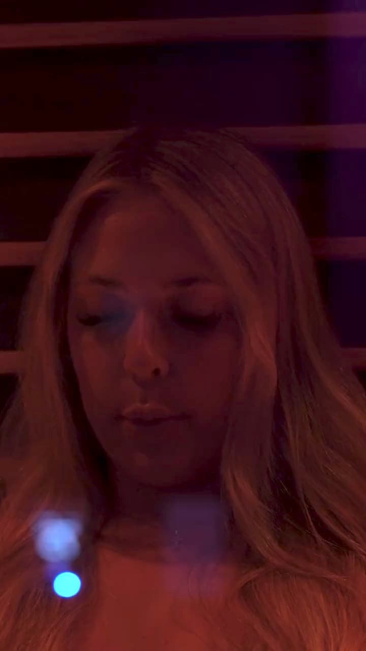 A guest resting in the red light of the infrared sauna, then easing into the cold plunge, filmed at the Temecula studio